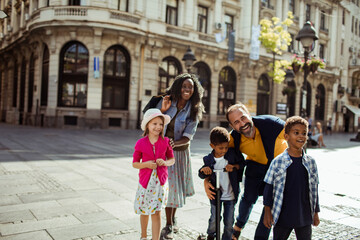 Joyful diverse family having fun on a city walk