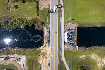 Damaged road bridge destroyed by river after flood water washed away asphalt. Rebuilding of ruined...
