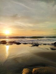 Yellow-orange sunset and sunrise on the ocean shore, Bali island. Epic sunrise, sandy beach. Landscape of Indonesia