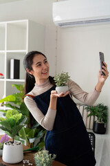 Hobby, asian young woman using mobile phone taking photo of pot, houseplant with dirt soil on table at home