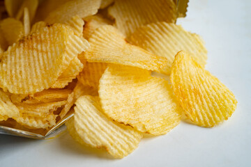 Potato chips, delicious BBQ seasoning spicy for crips, thin slice deep fried snack fast food in open bag.