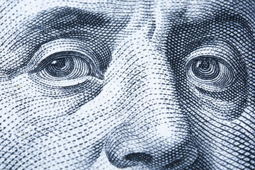 Macro image of eyes of Benjamin Franklin on the one hundred US Dollar bill.  Close up.