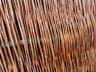 Close-up View of a Woven Brown Willow Fence