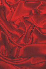 Rich and luxury red silk fabric texture background.