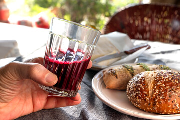 Delicious breakfast rolls with soft cheese and a glass of healthy beet juice