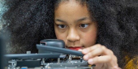 Girl female teen children concentrate enjoy Machine Learning Robot is Moving Under Control robot coding at technology stem class, stem education robot for digital automation artificial intelligence ai © BESTIMAGE