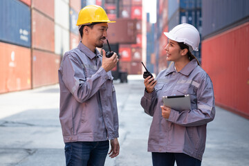 Portrait Asia logistic engineer woman worker or foreman use tablet computer and walkie talkie...