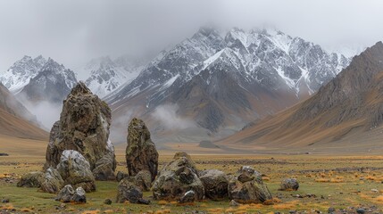   A rocky outcropping stands alone in the open field, mountain range distant, forming a picturesque backdrop