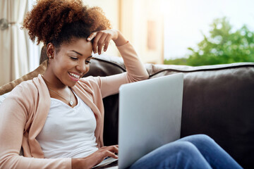 Happy, african woman or student with laptop on couch for remote learning, study or streaming tv at...