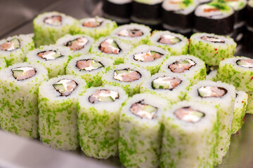 California roll sushi dish with green fines herbes toppings on table