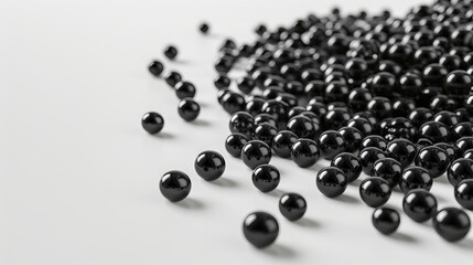 A pile of black balls on a white background.