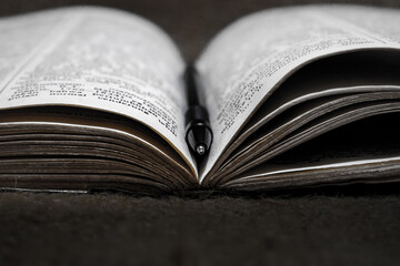 a pen on the middle page of an open book