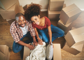 Portrait, boxes and black couple on floor in new home with moving, smile and mortgage with top...