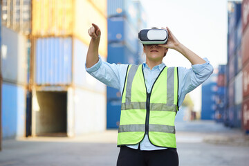 worker or engineer wearing virtual reality glasses(VR) in containers warehouse storage