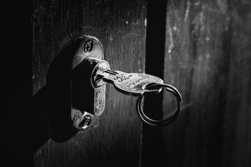 A rusty lock hangs on a wooden door.
