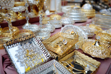 Decorative silver and gold trays and plates with mirrored bottoms, openwork patterns and crystal are sold at the Grand Bazaar in Istanbul.