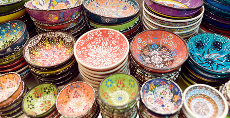 Sale of traditional colorful Turkish ceramics dishes in the Istanbul Grand Bazaar, Istanbul. Authentic gifts and souvenirs from travels in Turkey.