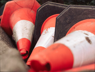 traffic cones piled together close up, red and reflective motor vehicle calming device