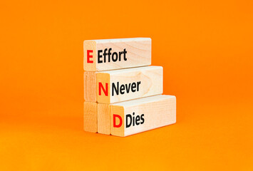 END effort never dies symbol. Concept words END effort never dies on beautiful wooden blocks. Beautiful orange background. Business END effort never dies concept. Copy space.