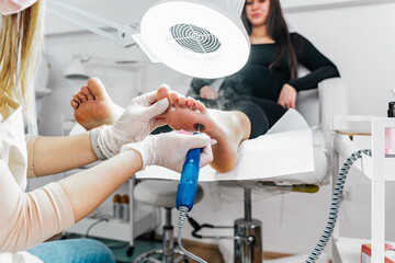 Professional podiatrist or chiropodist working. Foot and toenails beauty and hygienic treatments.