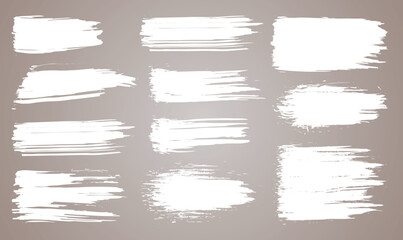 Paint brush. White ink grunge brush strokes. Vector paintbrush set. Grunge design elements. Painted ink stripes. Creative isolated spots. Ink smudge abstract shape stains and smear set