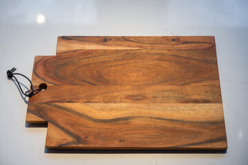 wooden cutting board on a white marble surface background