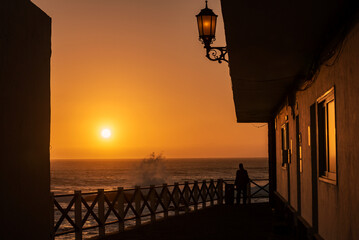 Silhouette of a man walking at sunset in El Cotillo town, Fuerteventura, Canary Islands, Spain