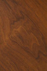 Walnut wood grain pattern. Natural material texture photograph. 
