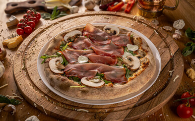 Delicious pizza with prosciutto and mushrooms