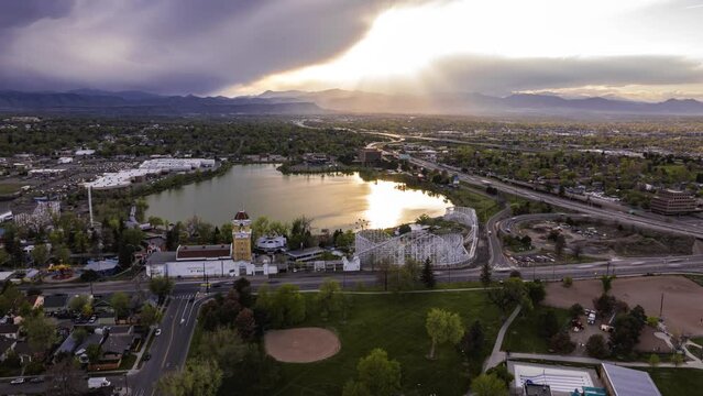 Sunset over the lake and amusement park, aerial hyperlapse, Lakewood, Colorado