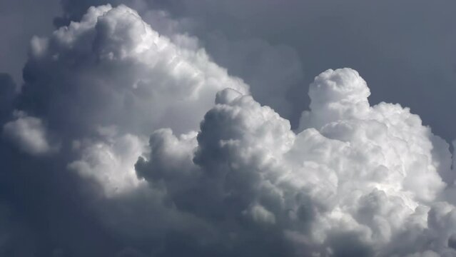 Boiling Clouds. Majestic clouds illuminated by the sun. Timelipse