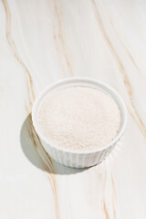 Celtic Gray Sea Salt In A White Ceramic Bowl On Granite Table, Copy Space. Vertical Plane. Natural And Unrefined Salt Harvested From Brittany, France. Natural Minerals And Trace Elements, Superfood