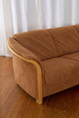 Vintage soft suede sofa. Mid-century modern couch. Photographed with luxurious long white curtains. 