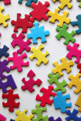 Obraz premium Colorful jigsaw puzzle pieces on white background. Flat lay.
