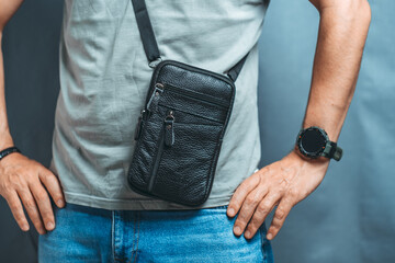 Hanging black leather bag man shoulder.