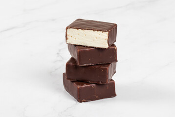 Vegan Delicate dessert. Vanilla souffle in chocolate glaze. Close-up. White background