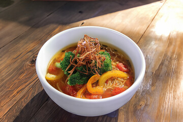 A hearty vegetable ramen soup topped with fried onions and broccoli