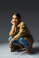 portrait of a teenager sitting on her knees