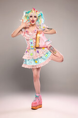 Pretty female clown model in colorful outfit and hair