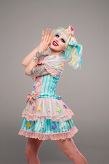 Pretty female clown model in colorful outfit and hair