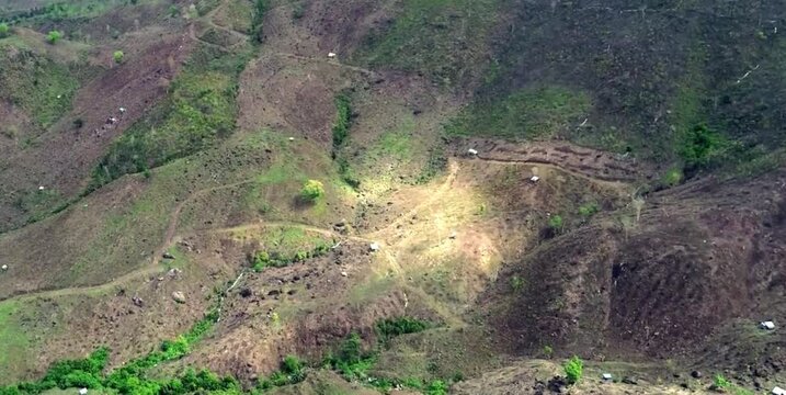 aerial video of deforested forests in mountainous areas being converted into agricultural land