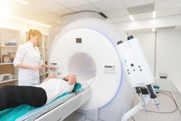 Female patient undergoing MRI - Magnetic resonance imaging in Hospital. Medical Equipment and...
