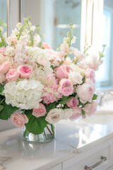Beautiful floral arrangement of pink roses and white hydrangea in a glass vase
