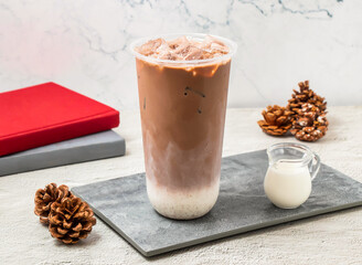 Iced Cocoa Latte served in disposable glass isolated on board side view of taiwanese iced drink