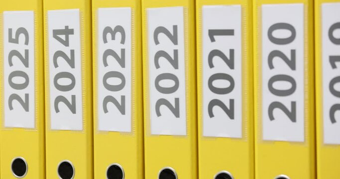 Shelf with thick folders with financial documentation