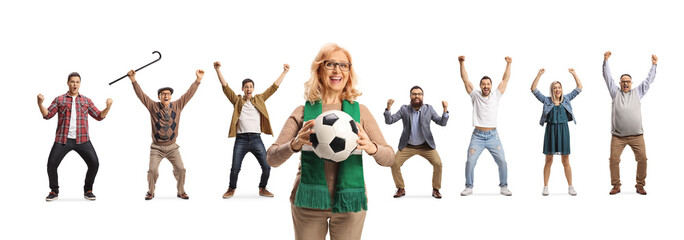 Woman holding a football and smiling with people cheering behind her