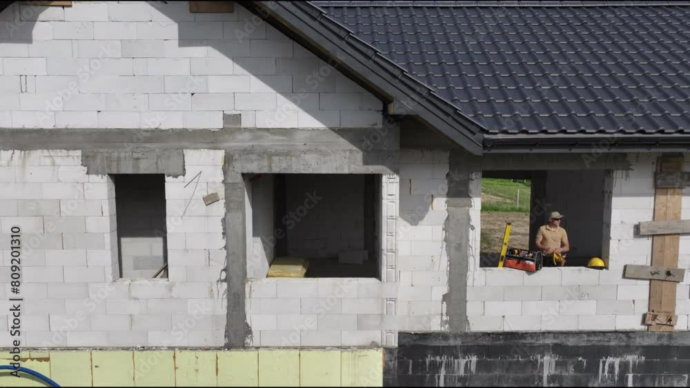 Wall mural man working on construction of house