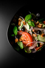 herb infused salad with olives, cucumber, tomato, purple onion, and croutons.