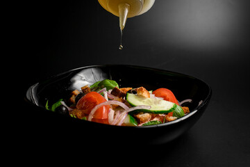 Herbal salad with olives, cucumbers, tomatoes, purple onions, and croutons.