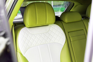 luxurious rear row of seats with light green leather in the SUV